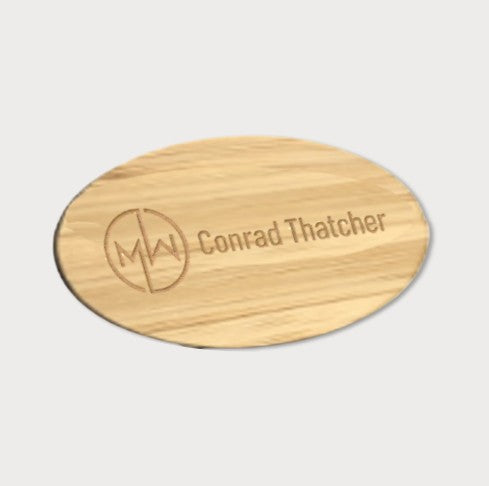 Oval wooden name badge. Logo and text
