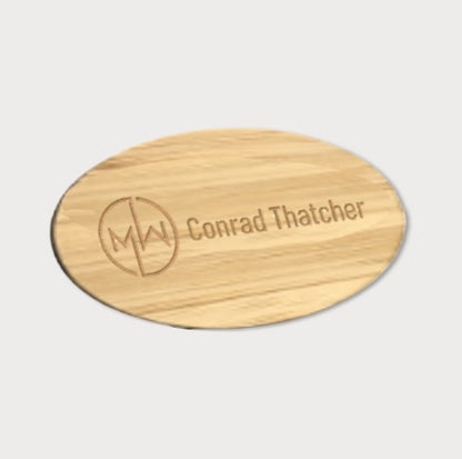 Oval wooden name badge. Logo and text